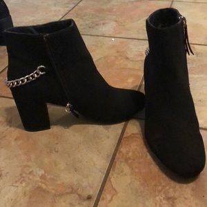Black heeled booties with chain accent